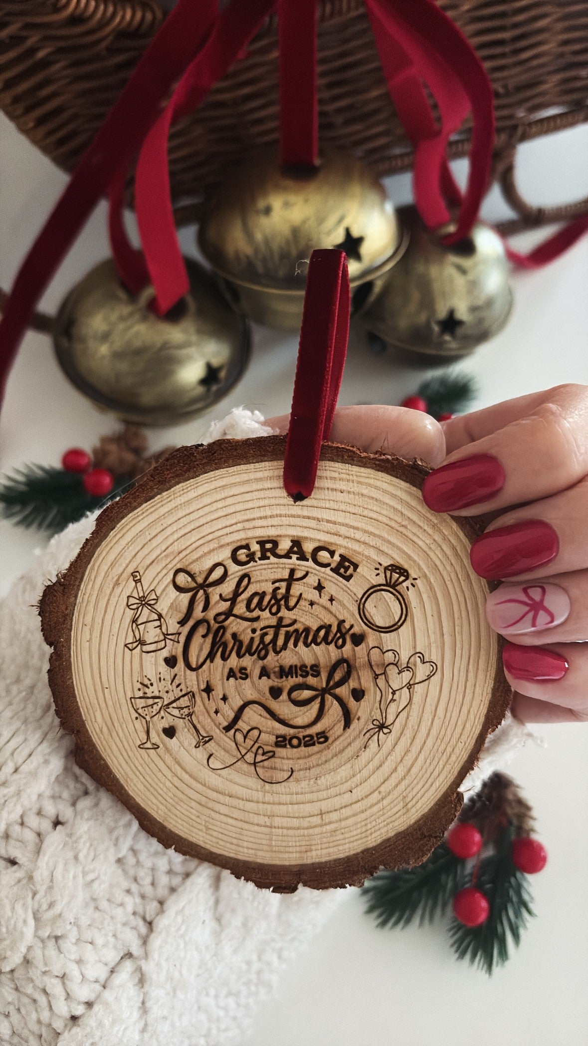 Personalised Last Christmas as a Miss wooden Christmas decoration engraved with bride's name, engagement ring, champagne glasses, wedding bells and red hanging ribbon.