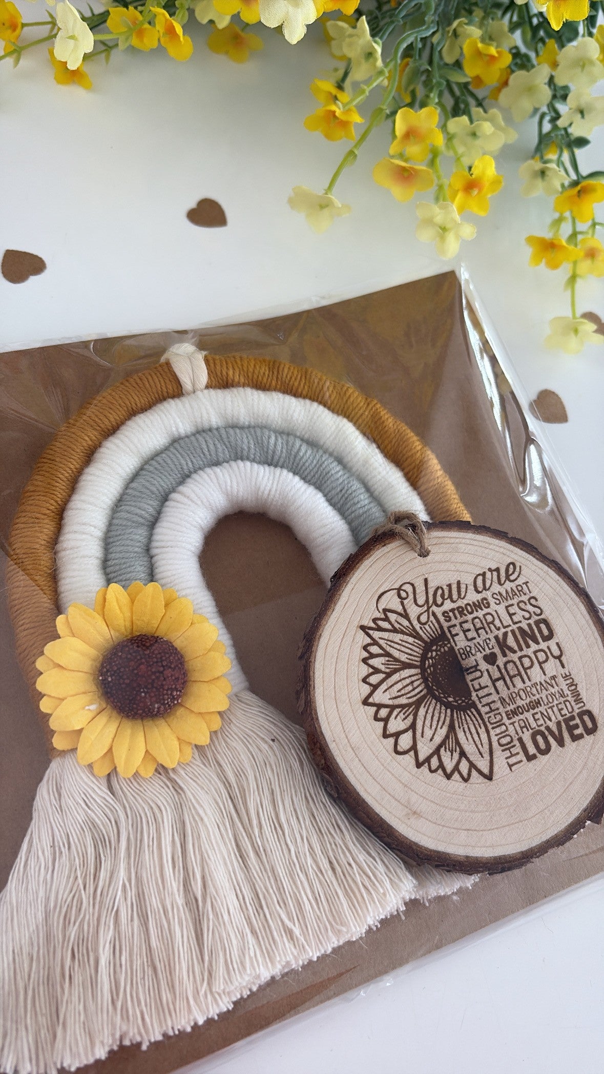 Decorative item with sunflower and wooden slice on a white background with yellow flowers.