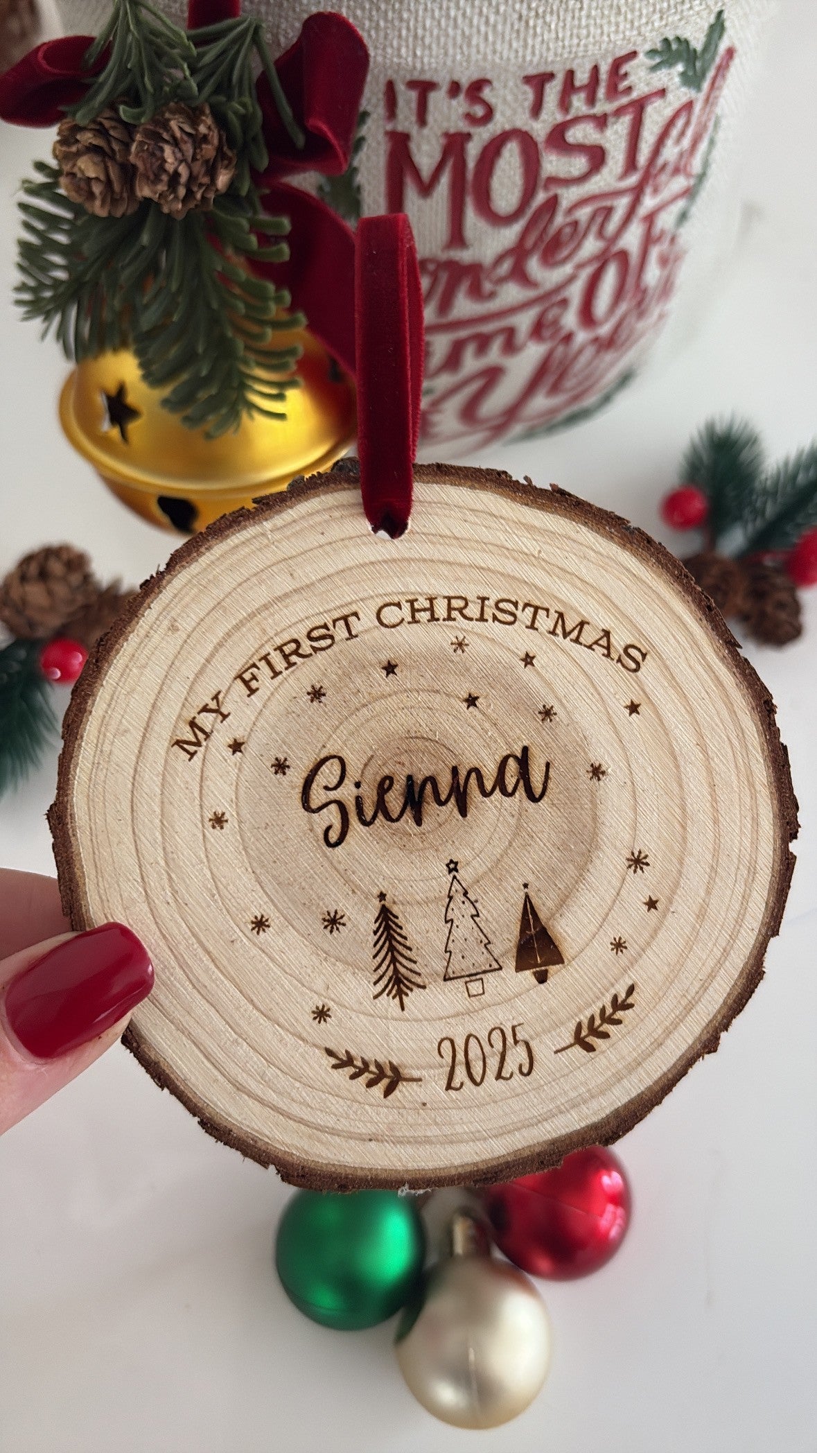 Engraved wooden disc with the words ‘My First Christmas,’ rustic baby keepsake made from natural wood.