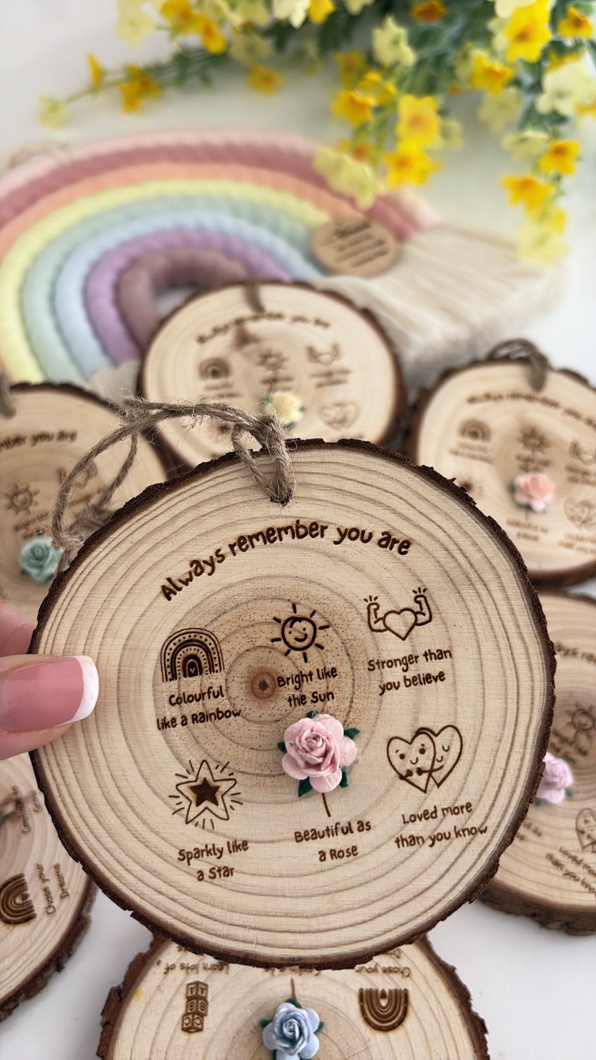 Natural wooden affirmation keepsake disc featuring the words "Always Remember You Are" with rainbow, sun, star, heart and rose illustrations, finished with a handcrafted flower and rustic twine.