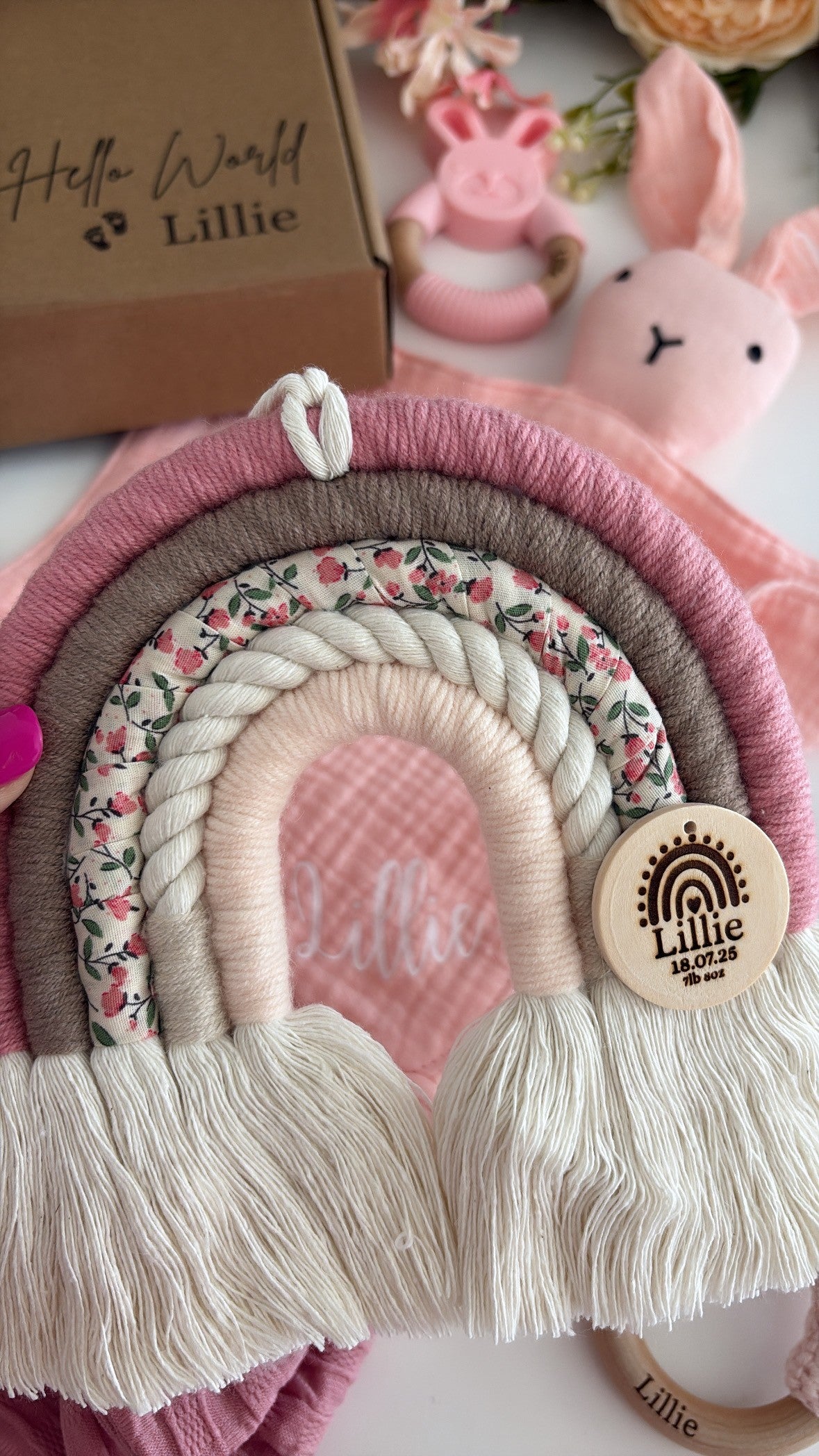 Personalised blush and taupe macramé rainbow with floral fabric and engraved wooden name tag — handmade baby gift.