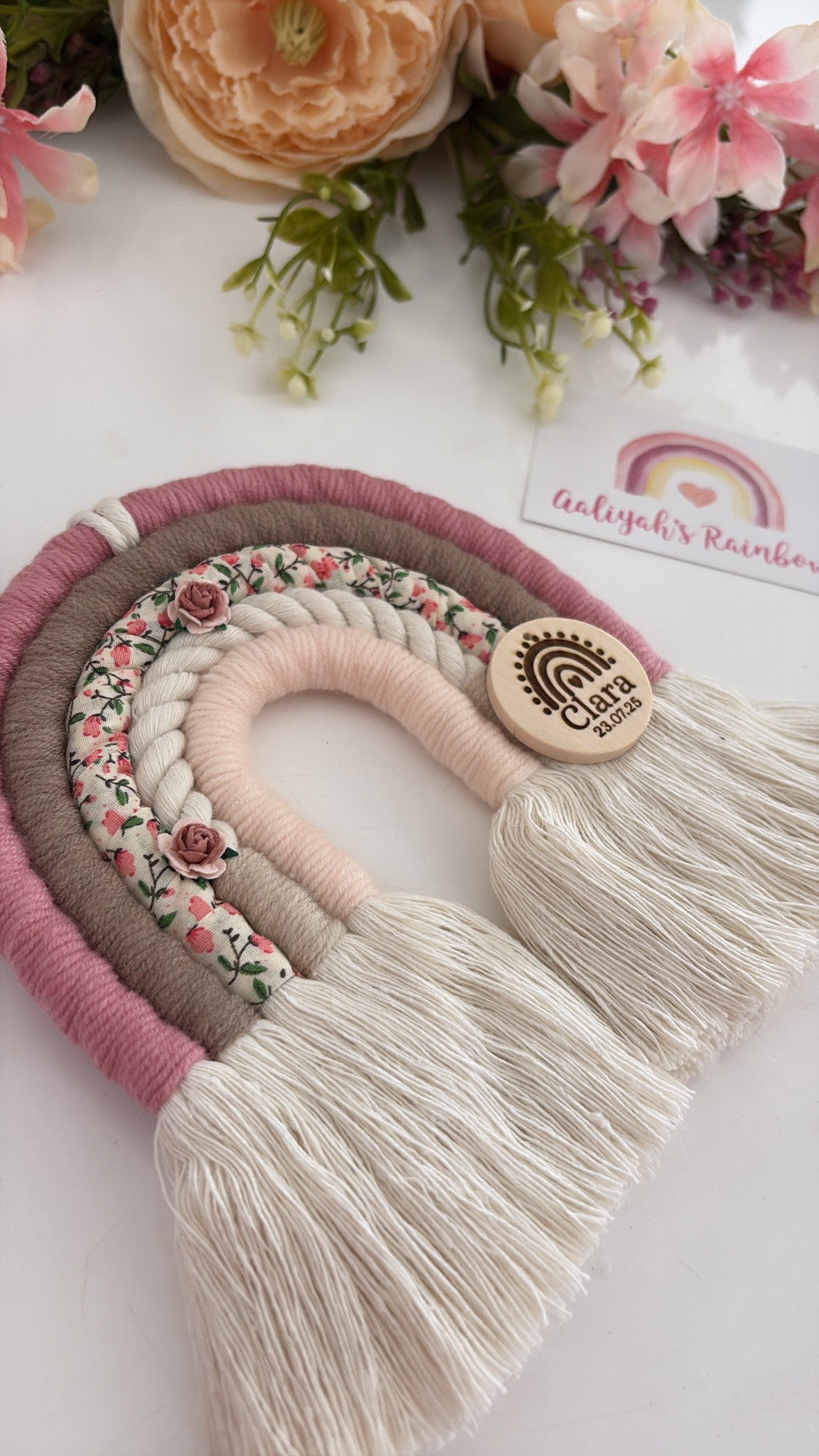 Personalised blush and taupe macramé rainbow with floral fabric and engraved wooden name tag — handmade baby gift.