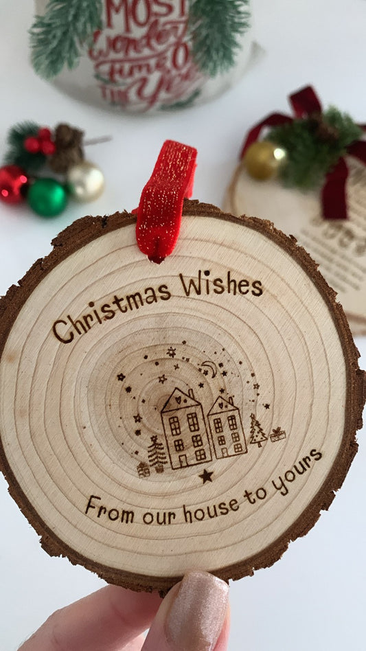 Laser engraved wooden Christmas ornament that reads “Christmas Wishes From Our House to Yours,” displayed with rustic jute twine and festive holiday déco