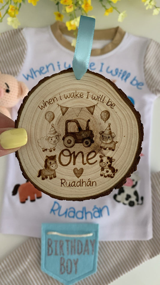 Personalised wooden engraved disc with farm-style design reading “When I wake I will be One” with custom child’s name