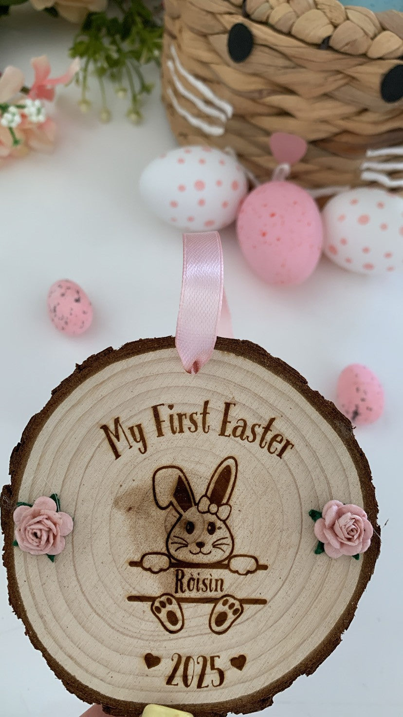 Personalised “My First Easter” wooden disc with bunny design, child’s name and 2025 engraving, rustic bark edge and pink ribbon hanger.