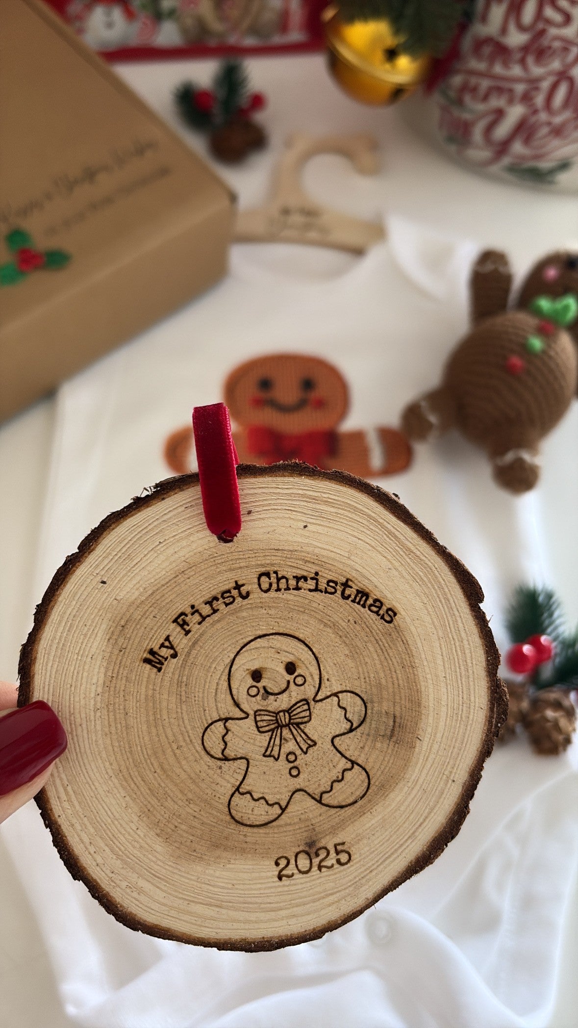 Festive baby gift set featuring gingerbread design and wooden first Christmas decoration