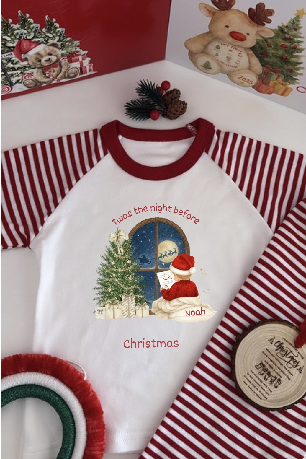 Christmas-themed children's shirt with Santa Claus design and text, surrounded by festive decor.