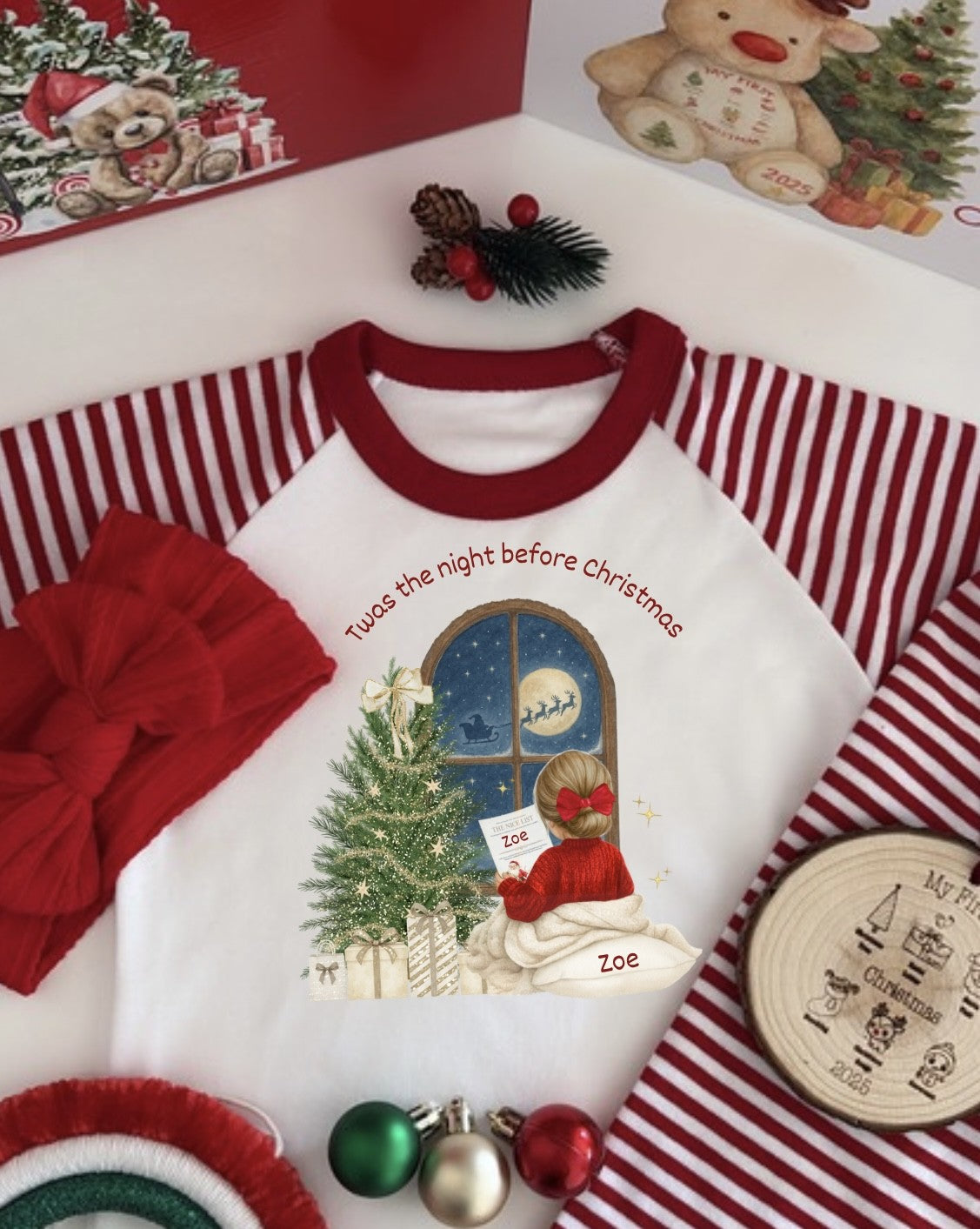 Children's Christmas-themed shirt with graphics and text, surrounded by festive items.