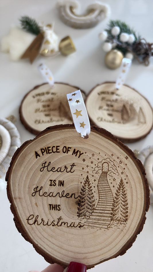 Engraved wooden ornament with “A piece of my heart is in Heaven this Christmas” quote and gold star ribbon