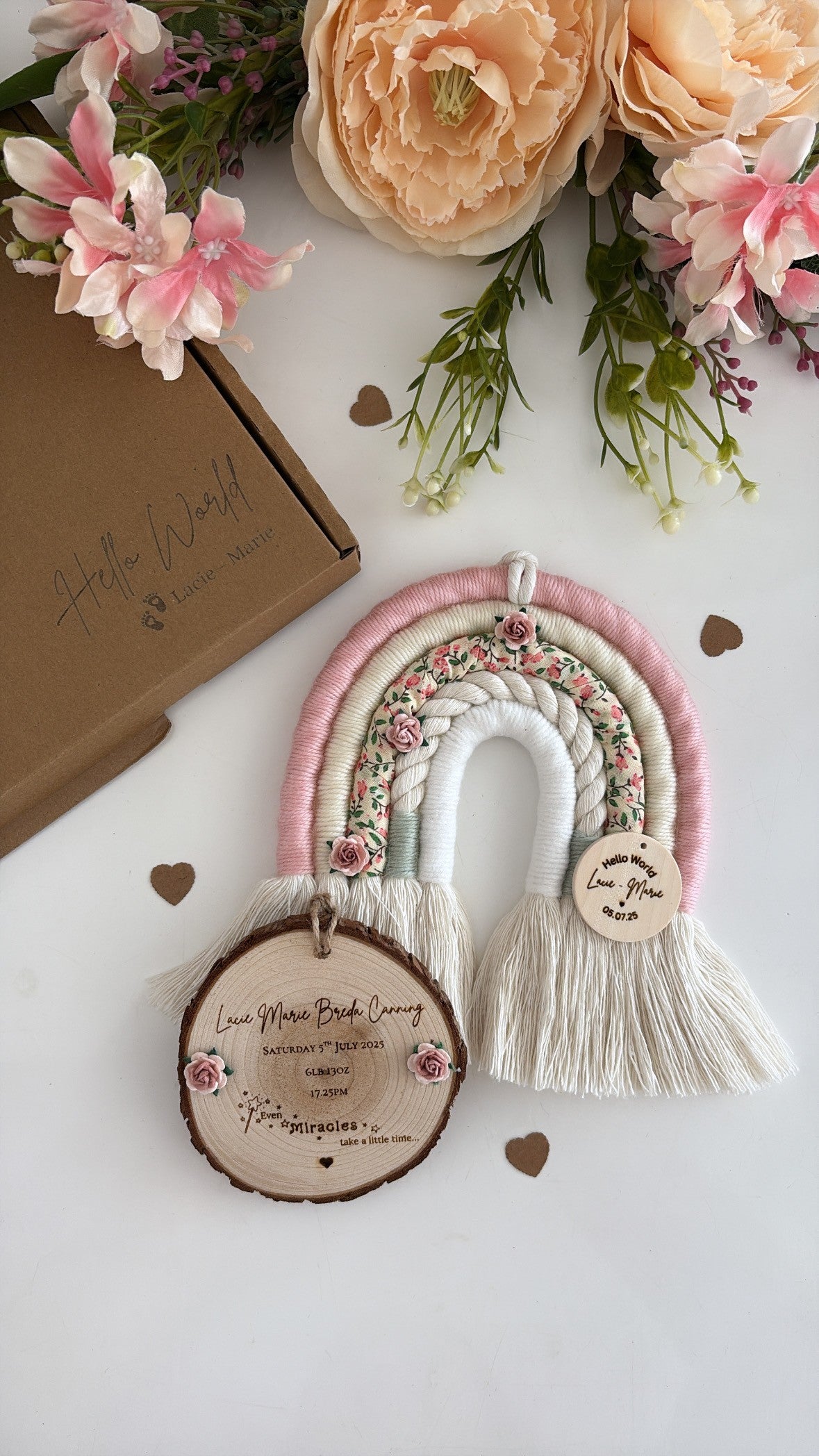 Personalised macramé rainbow baby gift in soft pink, cream and ditsy floral print with wooden engraved tag.