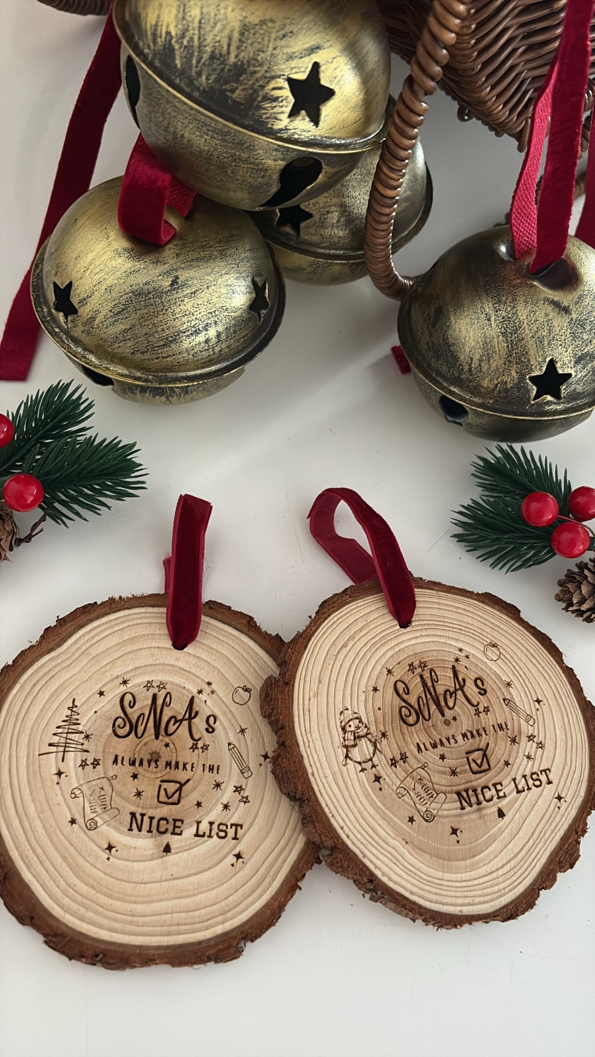 Personalised SNA Nice List wooden Christmas decorations with laser-engraved festive designs, natural bark edging and red hanging ribbons. Thoughtful Christmas gifts for Special Needs Assistants.