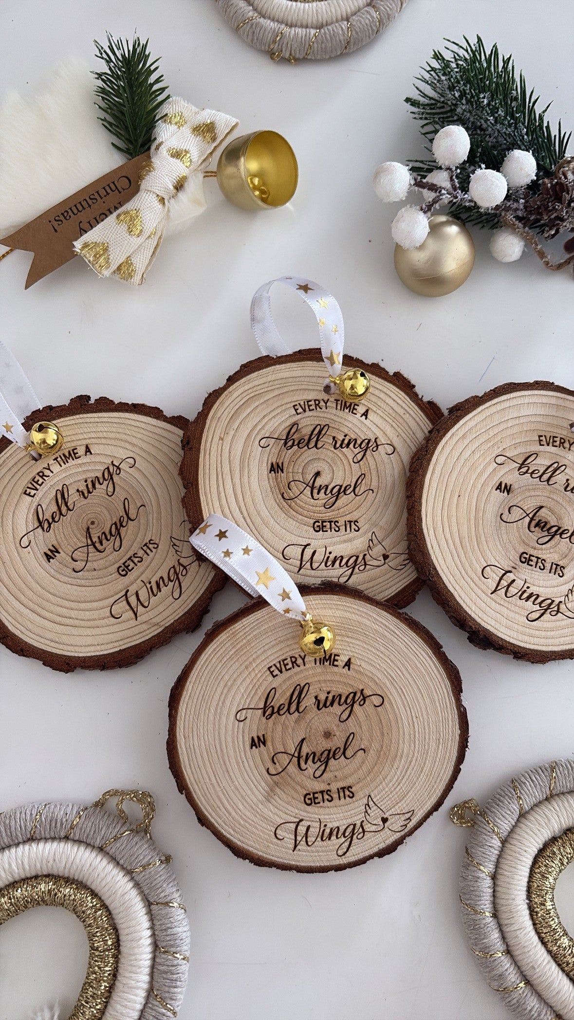 Engraved wooden ornament with “Every time a bell rings, an angel gets its wings” quote and gold ribbon