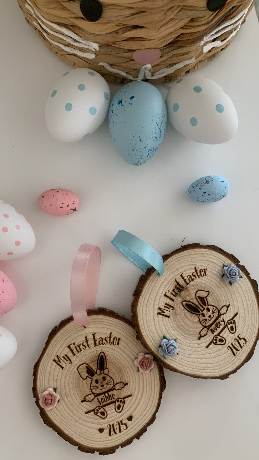 Two wooden Easter ornaments with ribbons and decorative eggs on a white background