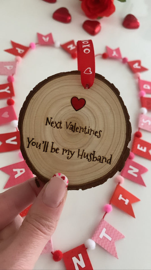Next Valentine’s you’ll be my husband wooden engraved disc with red XOXO ribbon