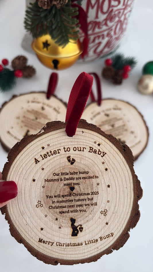 Baby Bump Christmas engraved wooden disc, rustic laser-engraved wooden ornament for pregnancy announcement or holiday keepsake.